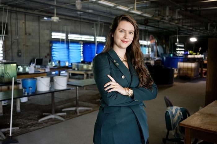 A female student posing in the Marine Science Research Lab