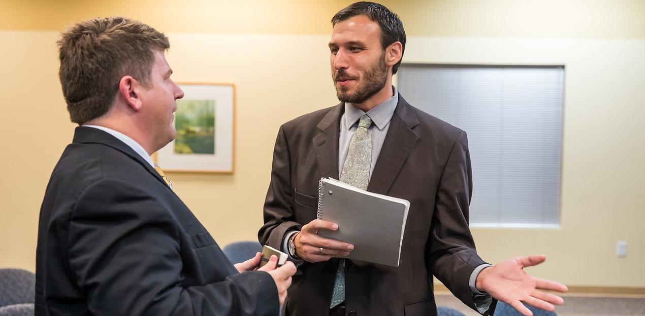 Two male Public Policy students having a conversation.